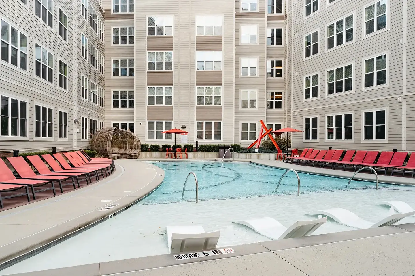 Large pool surrounded by lounging chairs.